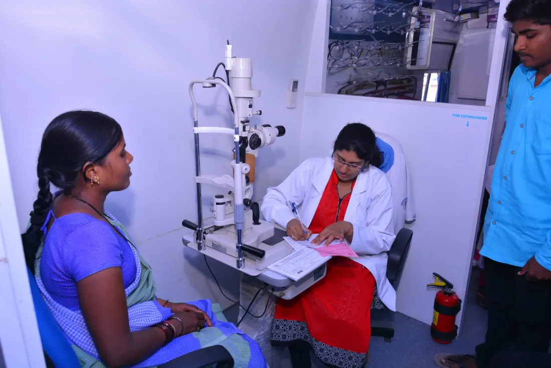 A patient undergoing a slit-lamp eye examination at the partner clinic