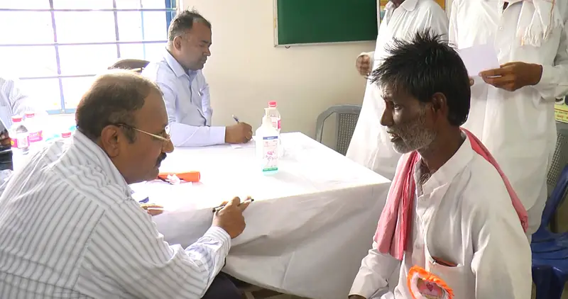 A doctor consulting a villager at the outpatient desk