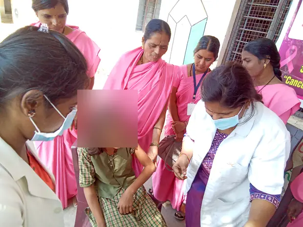 The first dose, given in the girl's own school.