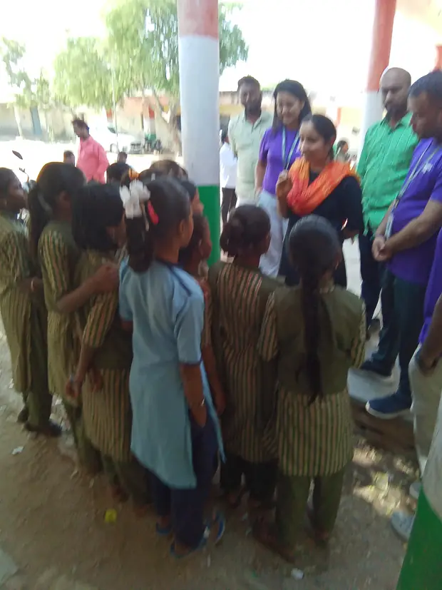Classmates wait their turn in the school yard.