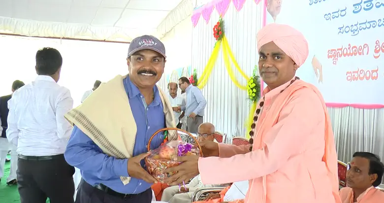 A Swamiji being honoured at a free health camp of the Trust