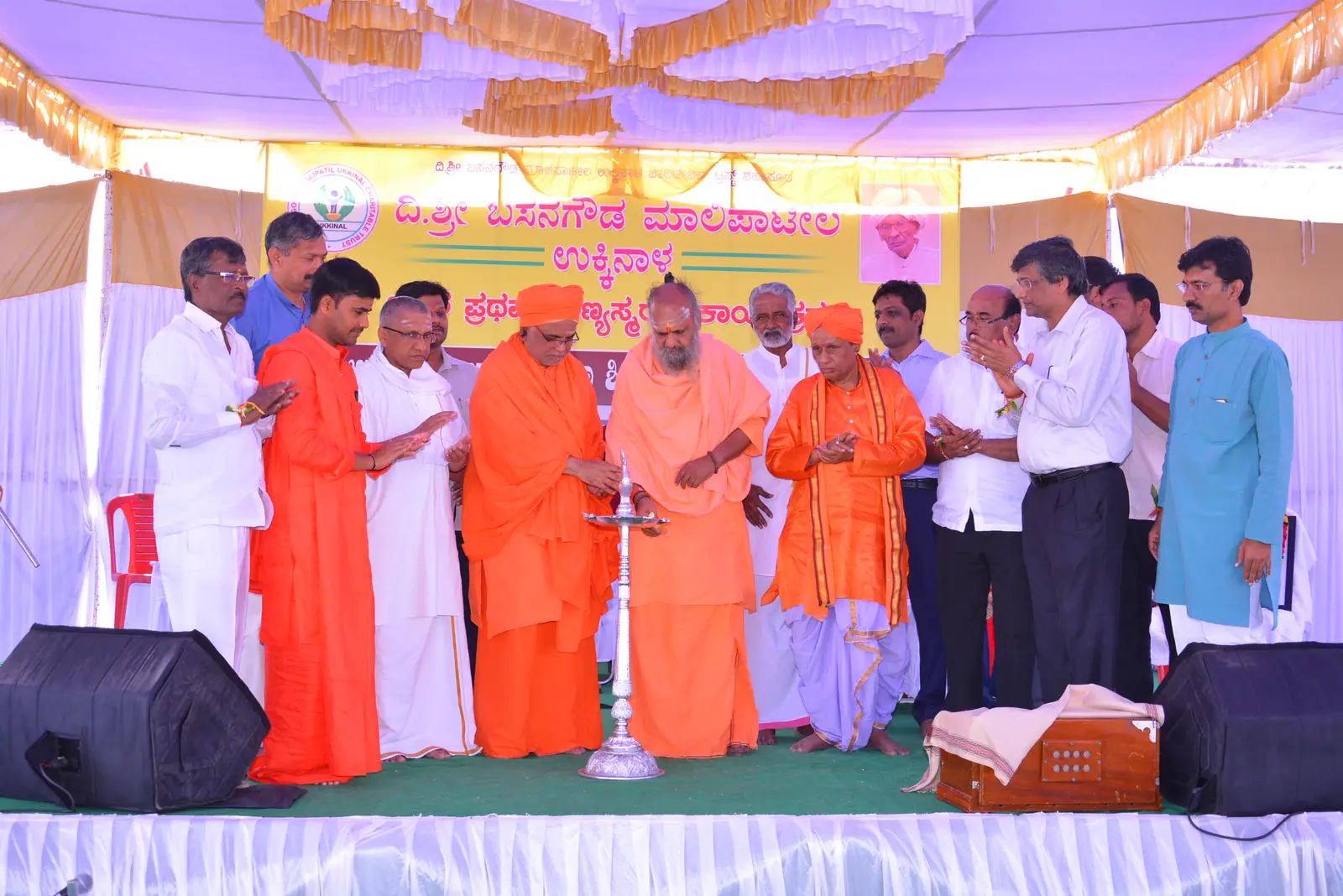 Seers and invited guests lighting the ceremonial lamp to inaugurate a programme of the Trust