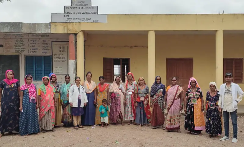Health workers and village women outside the Primary Health Centre where suspected cases are confirmed